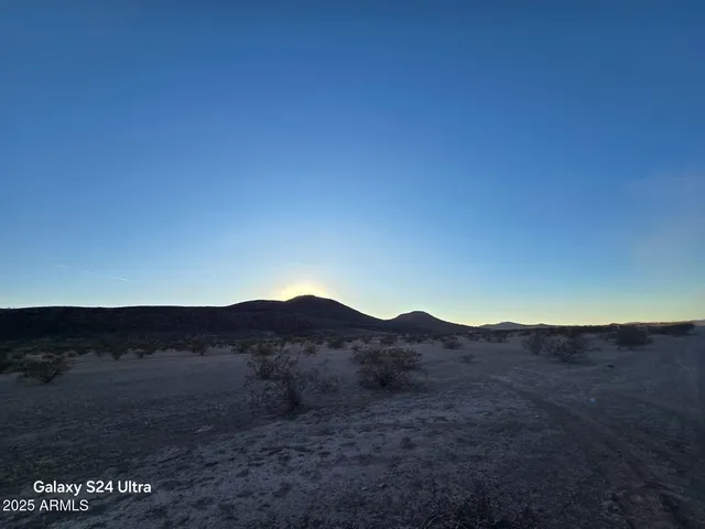 a view of a mountain with sunset view