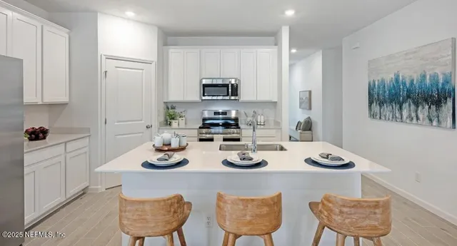 a kitchen with a dining table and chairs