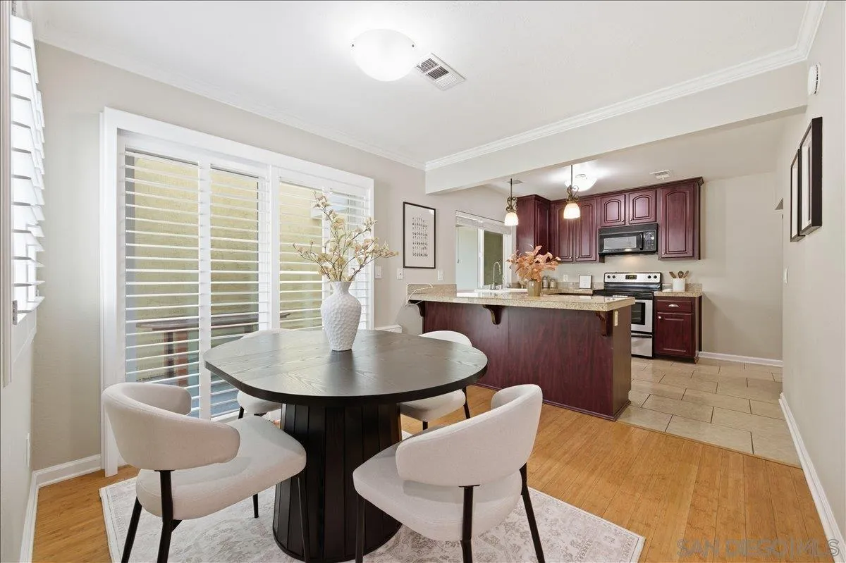 13619 Sycamore Tree Lane Poway, CA 92064 - Photo 12 of 40 a kitchen with a dining table chairs and a dining table