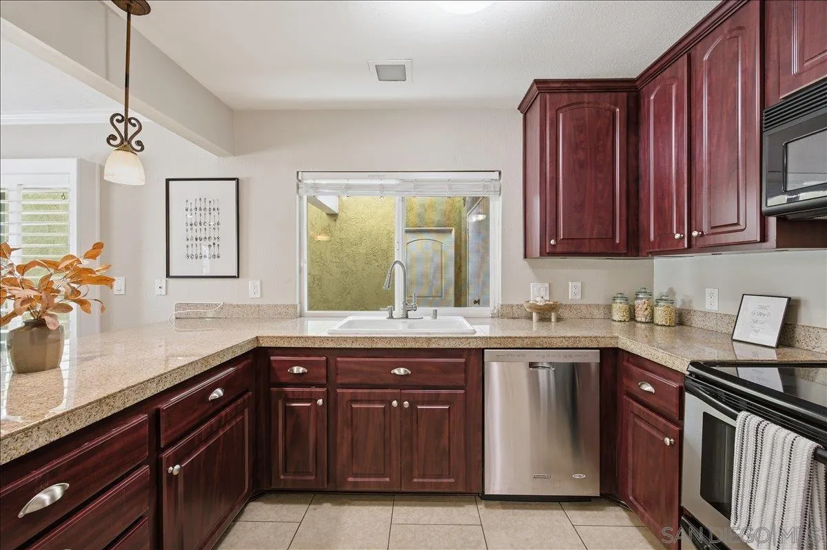 13619 Sycamore Tree Lane Poway, CA 92064 - Photo 14 of 40 a kitchen with a sink and a stove