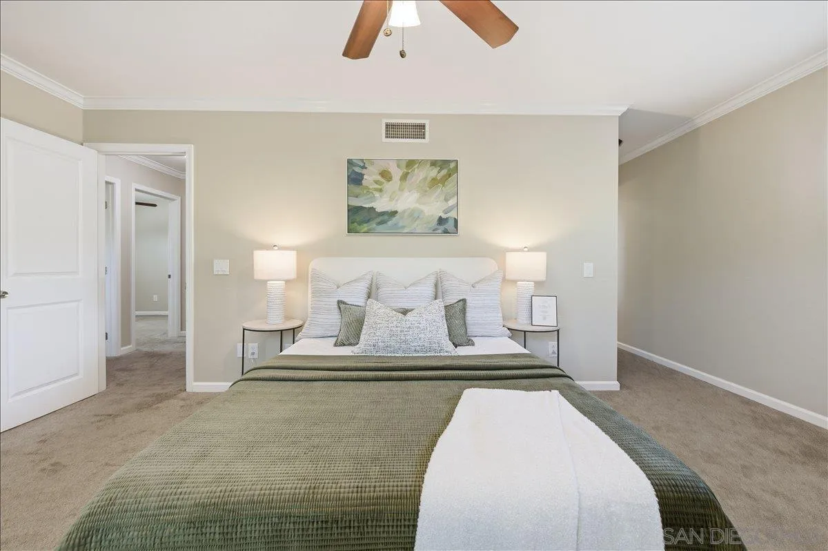13619 Sycamore Tree Lane Poway, CA 92064 - Photo 18 of 40 a spacious bedroom with a bed and a chandelier