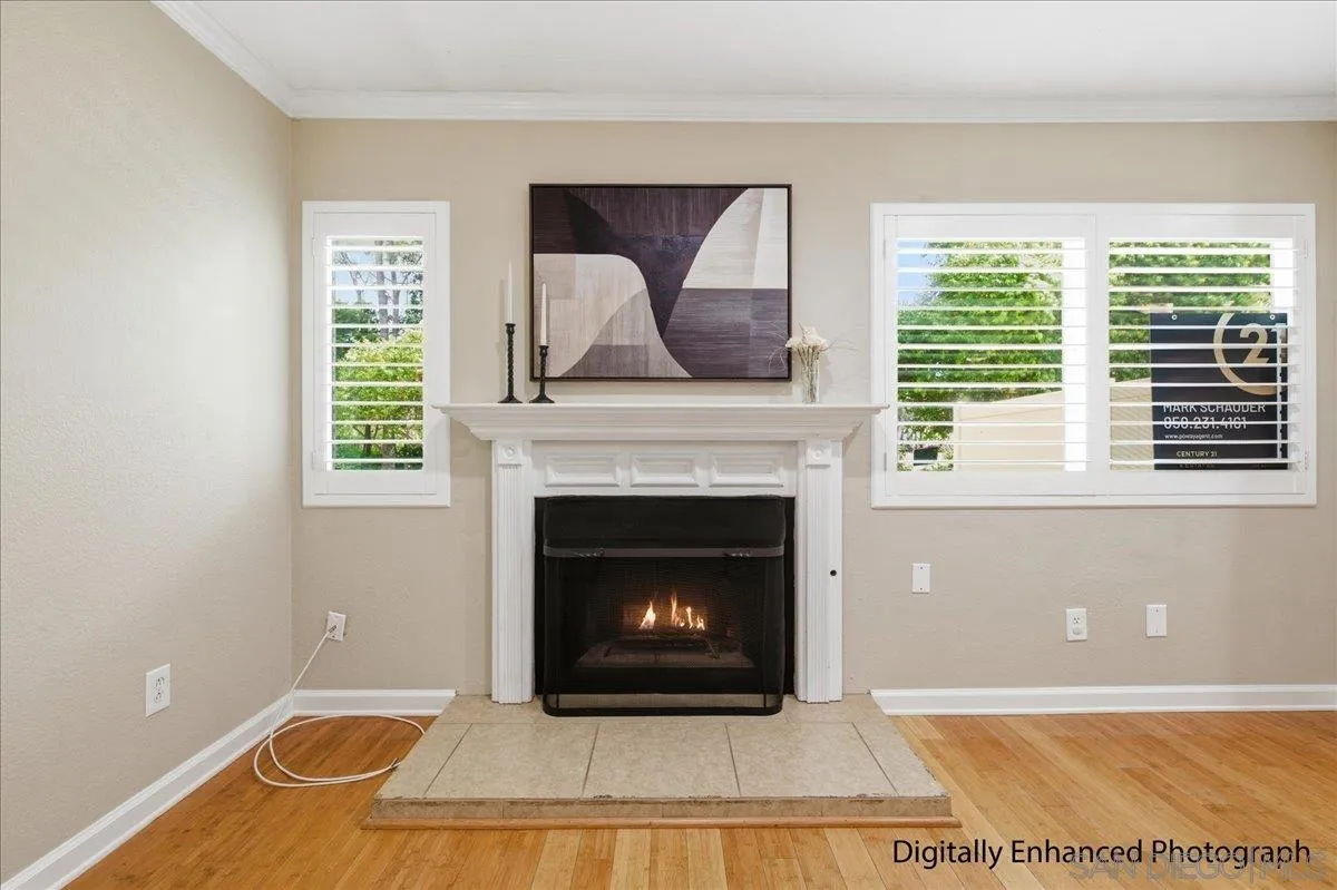 13619 Sycamore Tree Lane Poway, CA 92064 - Photo 8 of 40 a living room with a fireplace and a floor to ceiling window