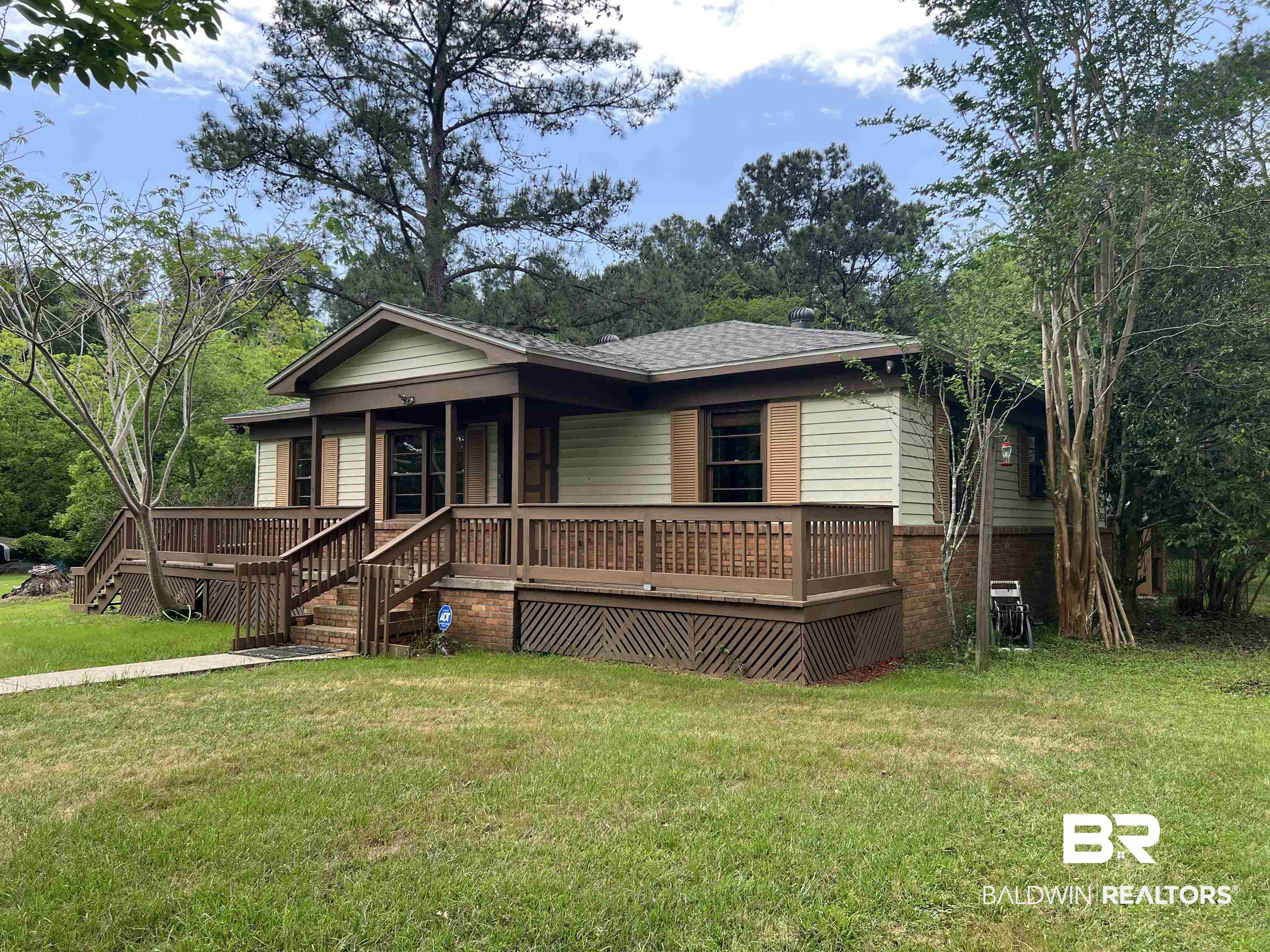 13301 A Hugh Fort Road Grand Bay, AL 36541 - Photo 1 of 34 View of front of home featuring a front yard, brick siding, and a porch