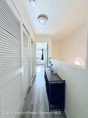 a hallway with a table and chairs