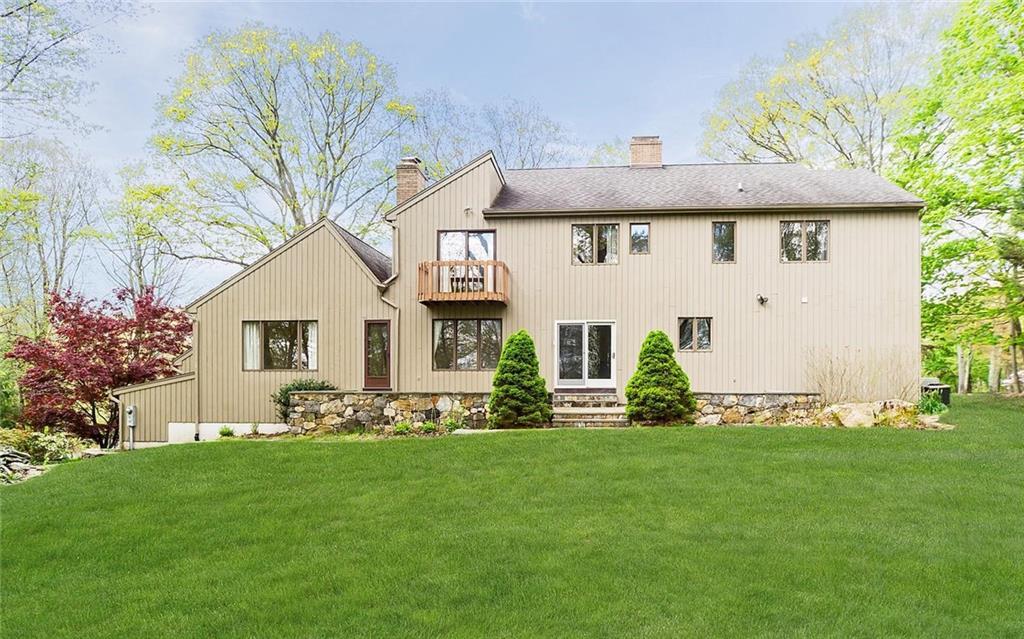 87 Armand Road Ridgefield, CT 06877 - Photo 1 of 1 a front view of a house with a yard