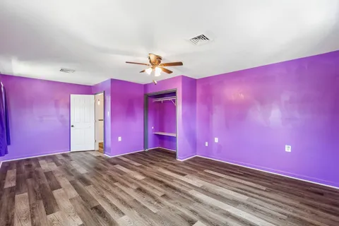 a view of a livingroom with a window and a ceiling fan