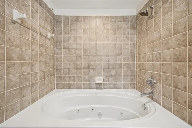 a white bath tub and a shower