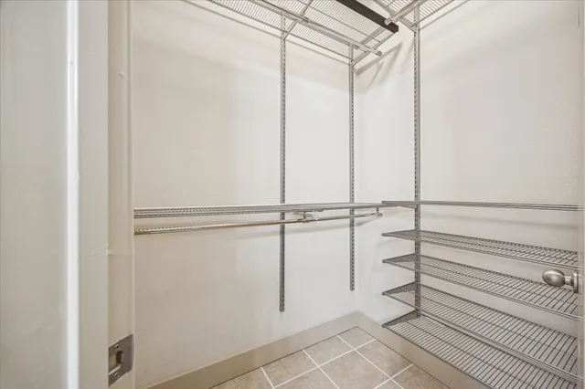 a view of a room with rack on the wall and a shower