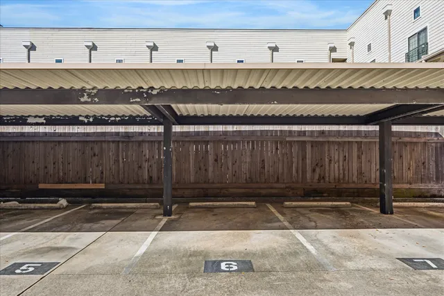 a view of a building with car parked