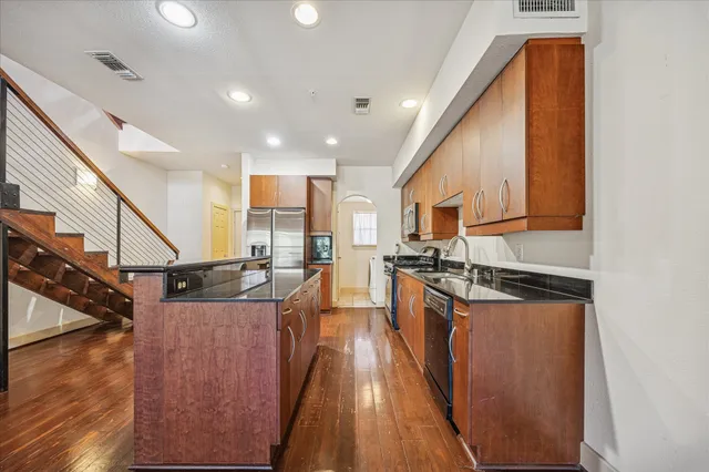 a kitchen with stainless steel appliances granite countertop lots of counter top space
