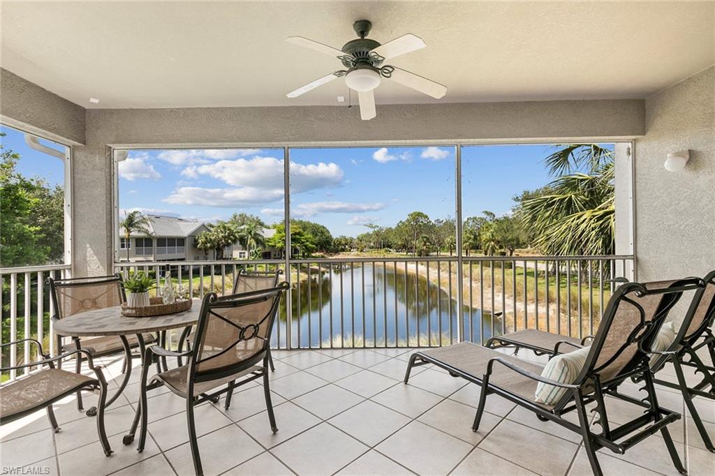 7132 Timberland Circle, Unit 201 Naples, FL 34109 - Photo 13 of 46 a living room with furniture and a floor to ceiling window