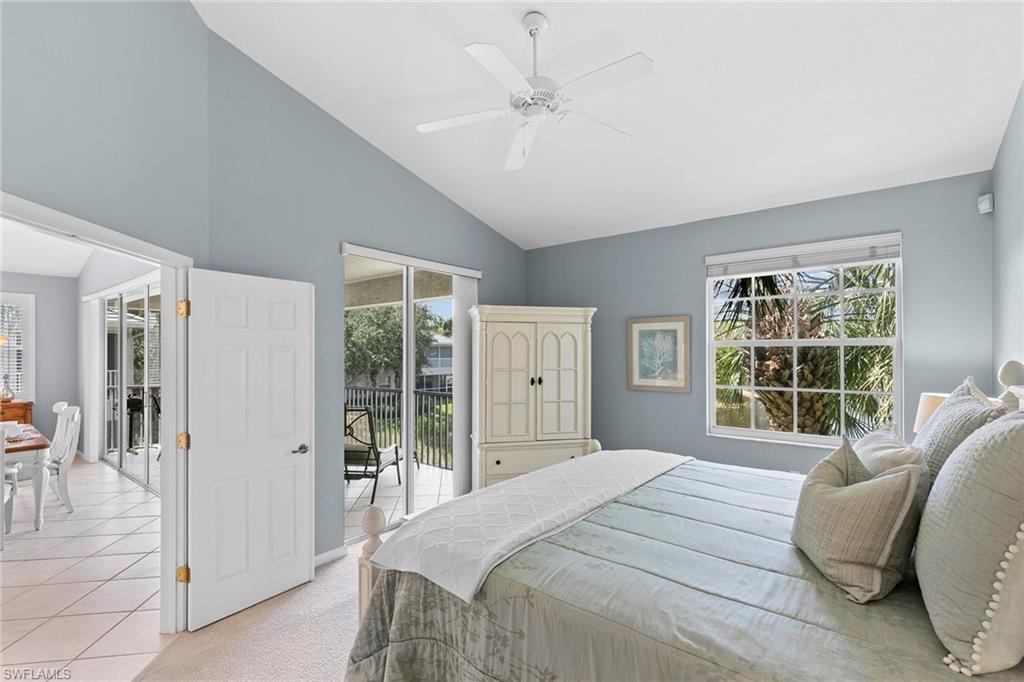 7132 Timberland Circle, Unit 201 Naples, FL 34109 - Photo 14 of 46 a bedroom with a large bed and a window