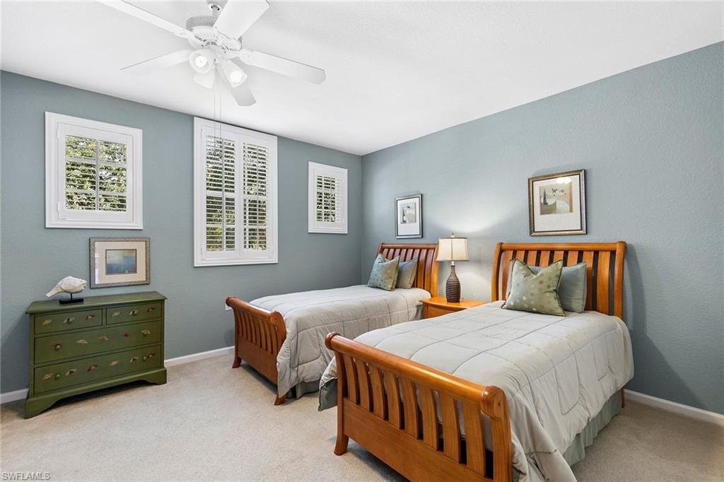 7132 Timberland Circle, Unit 201 Naples, FL 34109 - Photo 20 of 46 a bedroom with double bed and a window