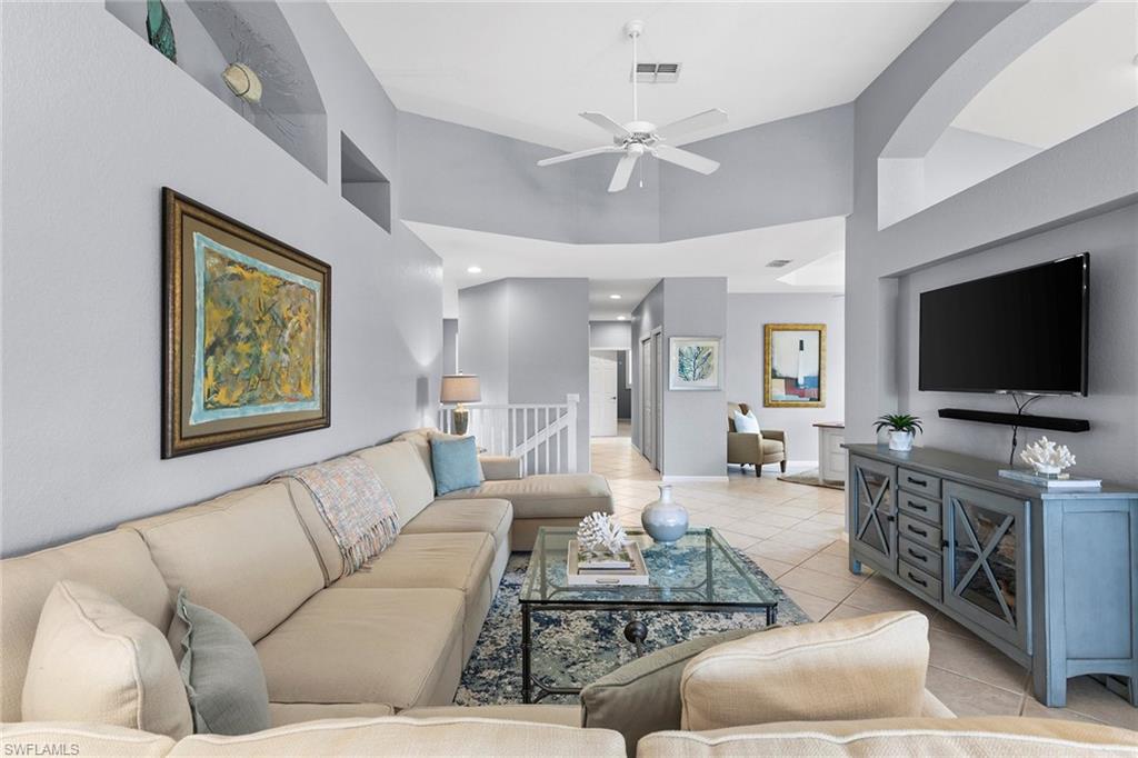 7132 Timberland Circle, Unit 201 Naples, FL 34109 - Photo 2 of 46 a living room with furniture and a flat screen tv