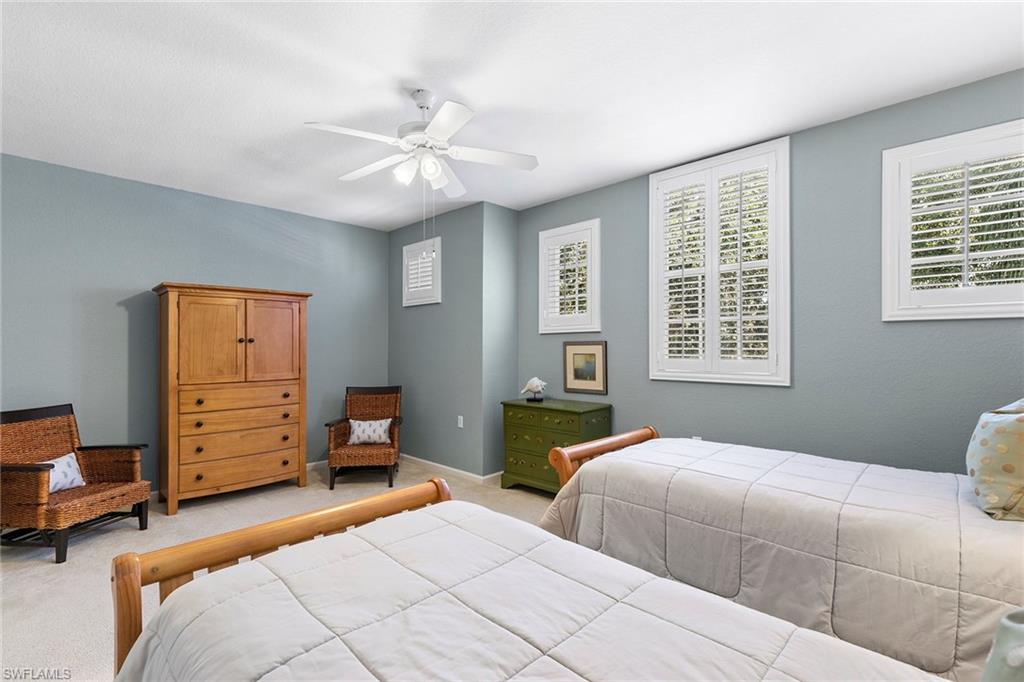 7132 Timberland Circle, Unit 201 Naples, FL 34109 - Photo 21 of 46 a bedroom with two beds and a window