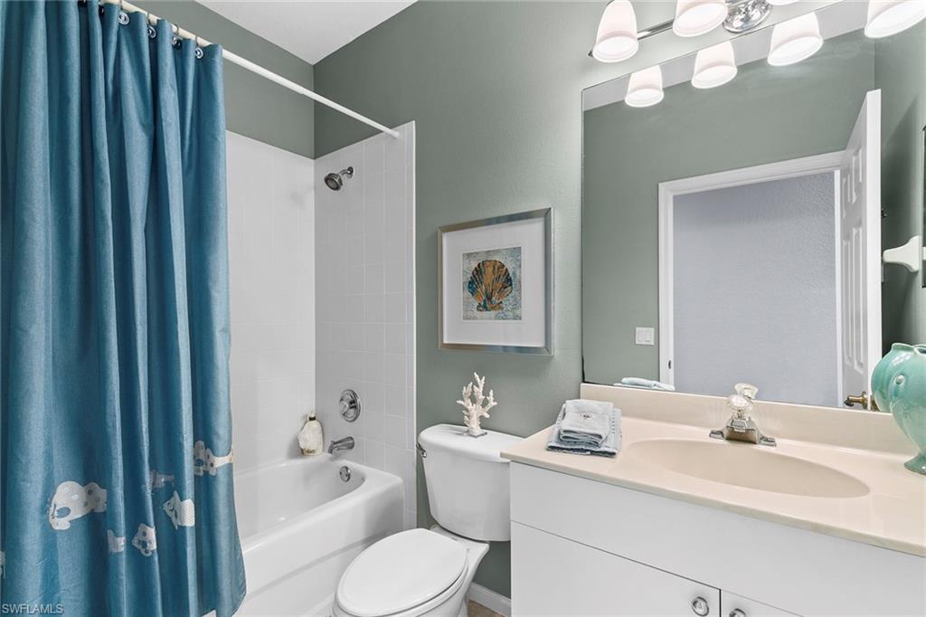 7132 Timberland Circle, Unit 201 Naples, FL 34109 - Photo 23 of 46 a bathroom with a sink a toilet and shower