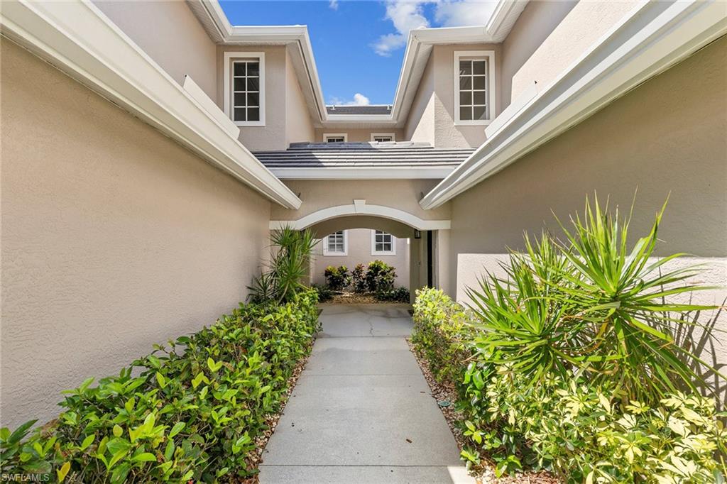 7132 Timberland Circle, Unit 201 Naples, FL 34109 - Photo 29 of 46 a front view of a house with garden