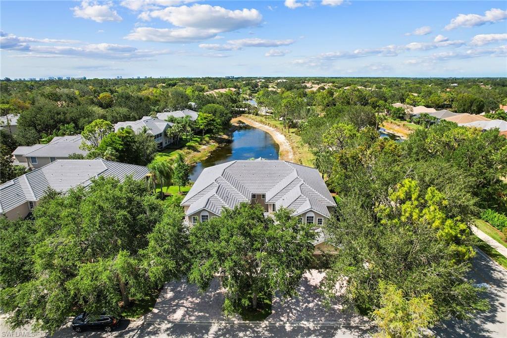 7132 Timberland Circle, Unit 201 Naples, FL 34109 - Photo 30 of 46 a view of a lake with a building in the background