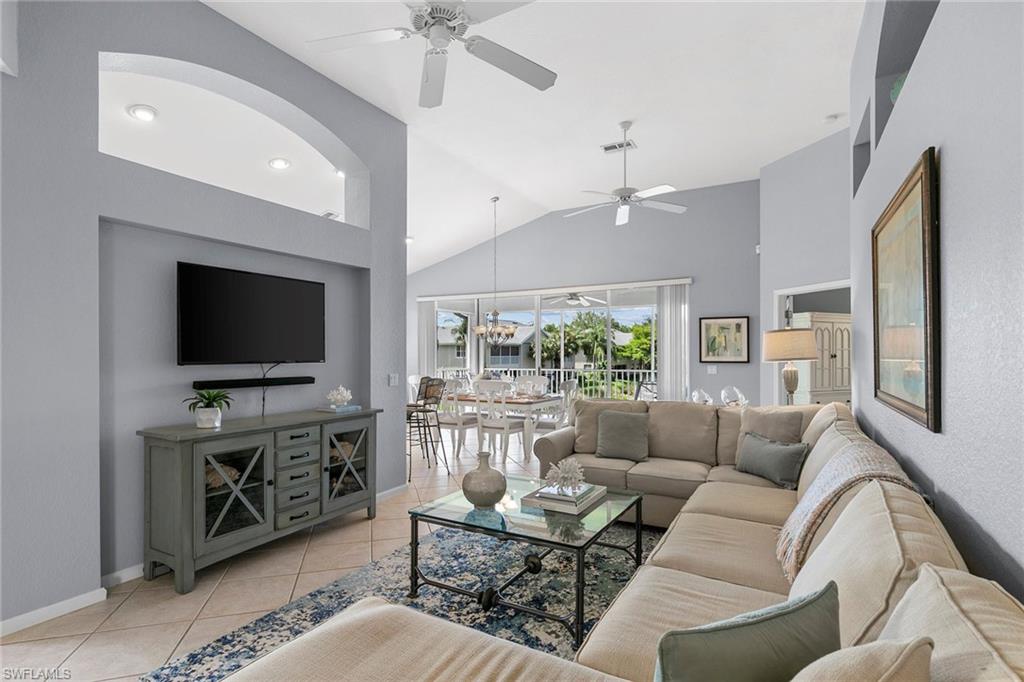 7132 Timberland Circle, Unit 201 Naples, FL 34109 - Photo 4 of 46 a living room with furniture and a flat screen tv