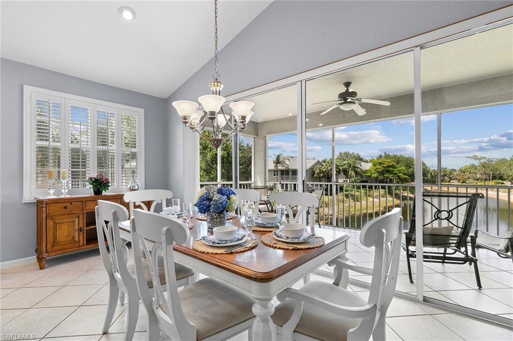 7132 Timberland Circle, Unit 201 Naples, FL 34109 - Photo 10 of 46 a dining room with furniture a chandelier and large window