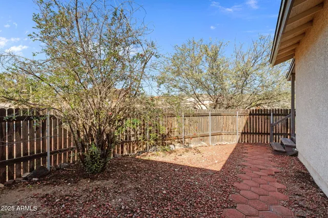 a view of a yard with large trees