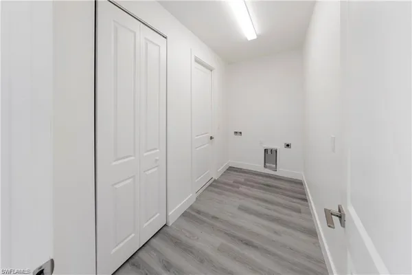 a view of a room with wooden floor