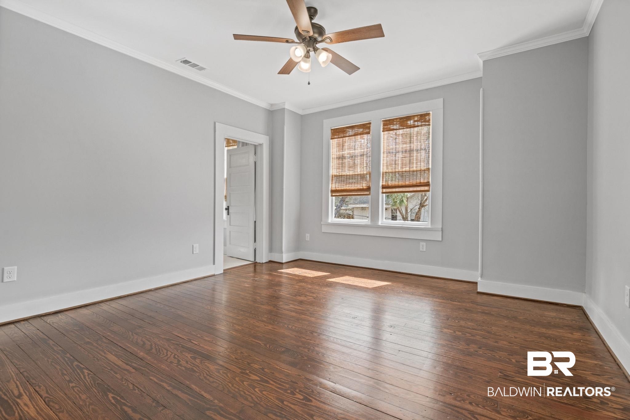 123 Macy Place Mobile, AL 36604 - Photo 13 of 35 Unfurnished bedroom with dark wood-type flooring, crown molding, and ceiling fan