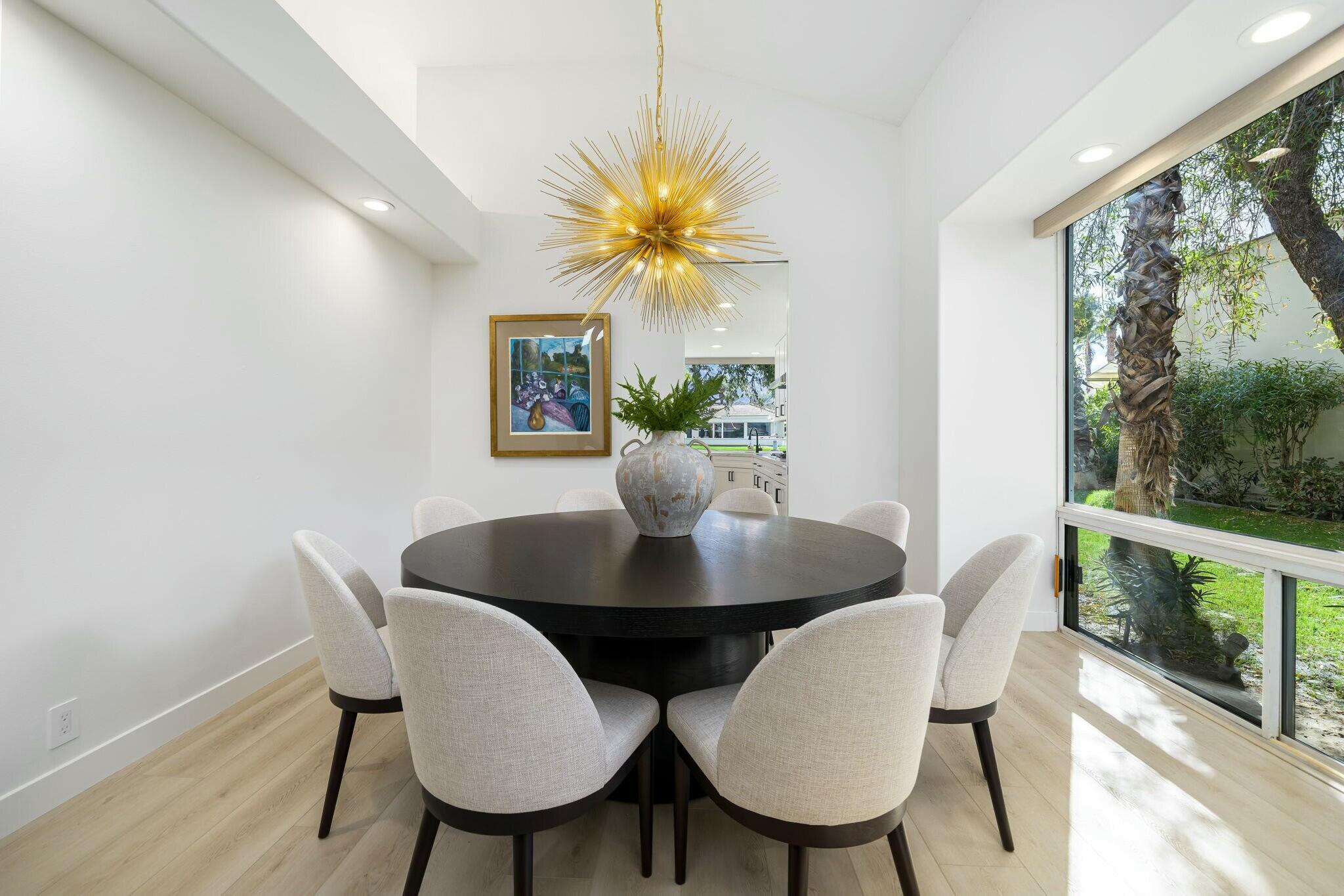75405 Riviera Drive Indian Wells, CA 92210 - Photo 20 of 43 a view of a dining room with furniture and a potted plant