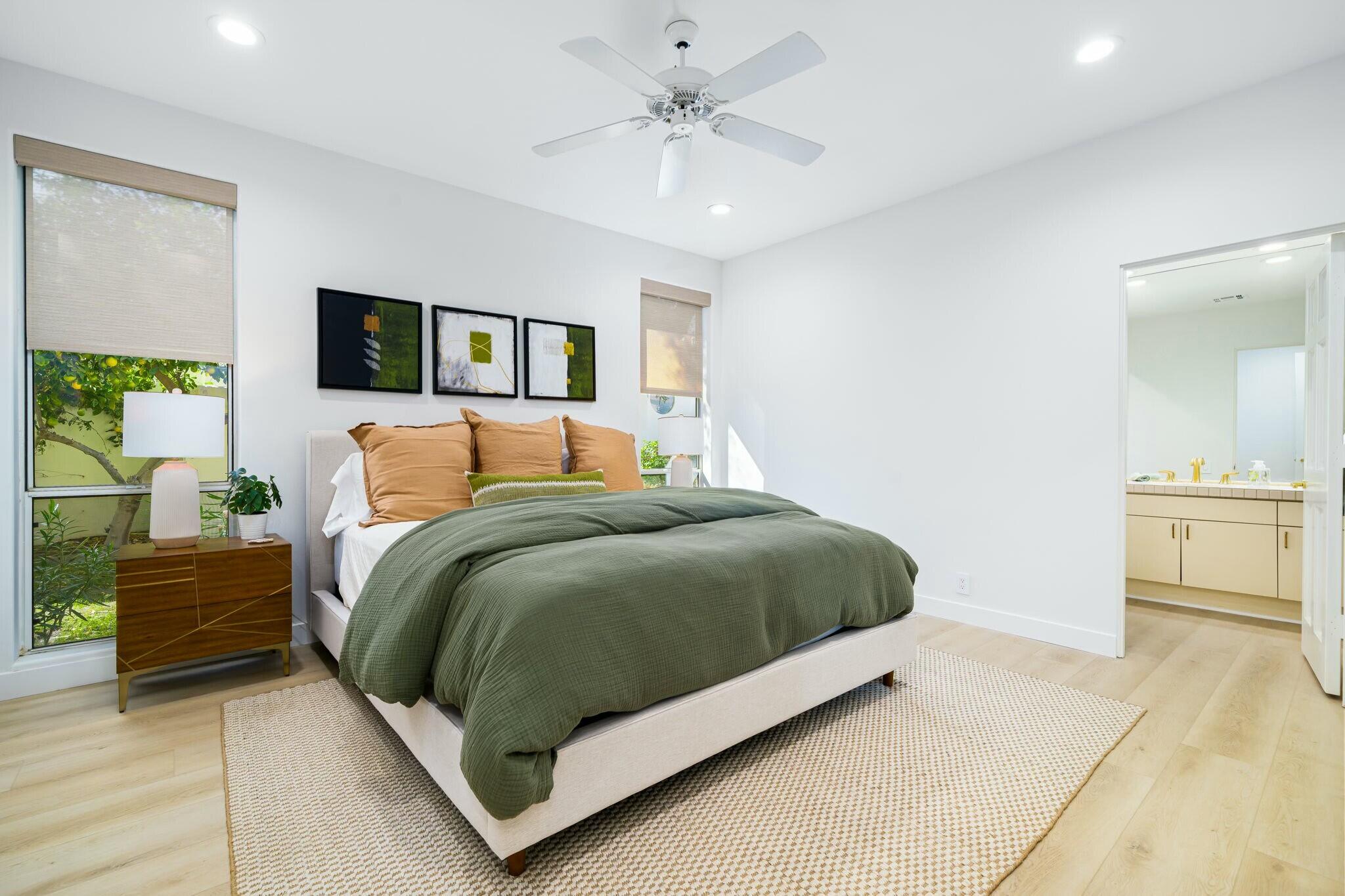 75405 Riviera Drive Indian Wells, CA 92210 - Photo 27 of 43 a bedroom with a bed and a chandelier