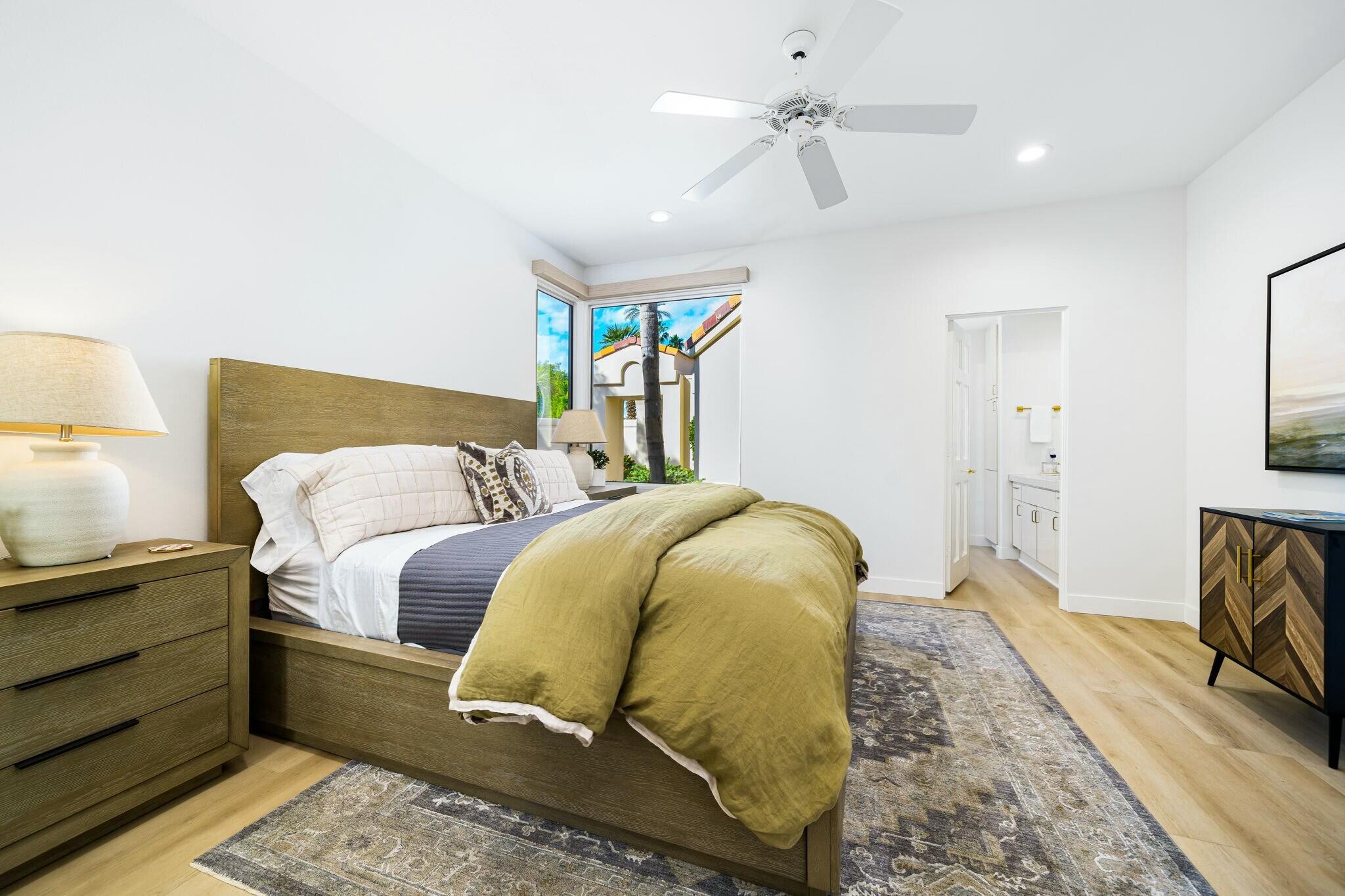 75405 Riviera Drive Indian Wells, CA 92210 - Photo 30 of 43 a bedroom with a bed and wooden floor