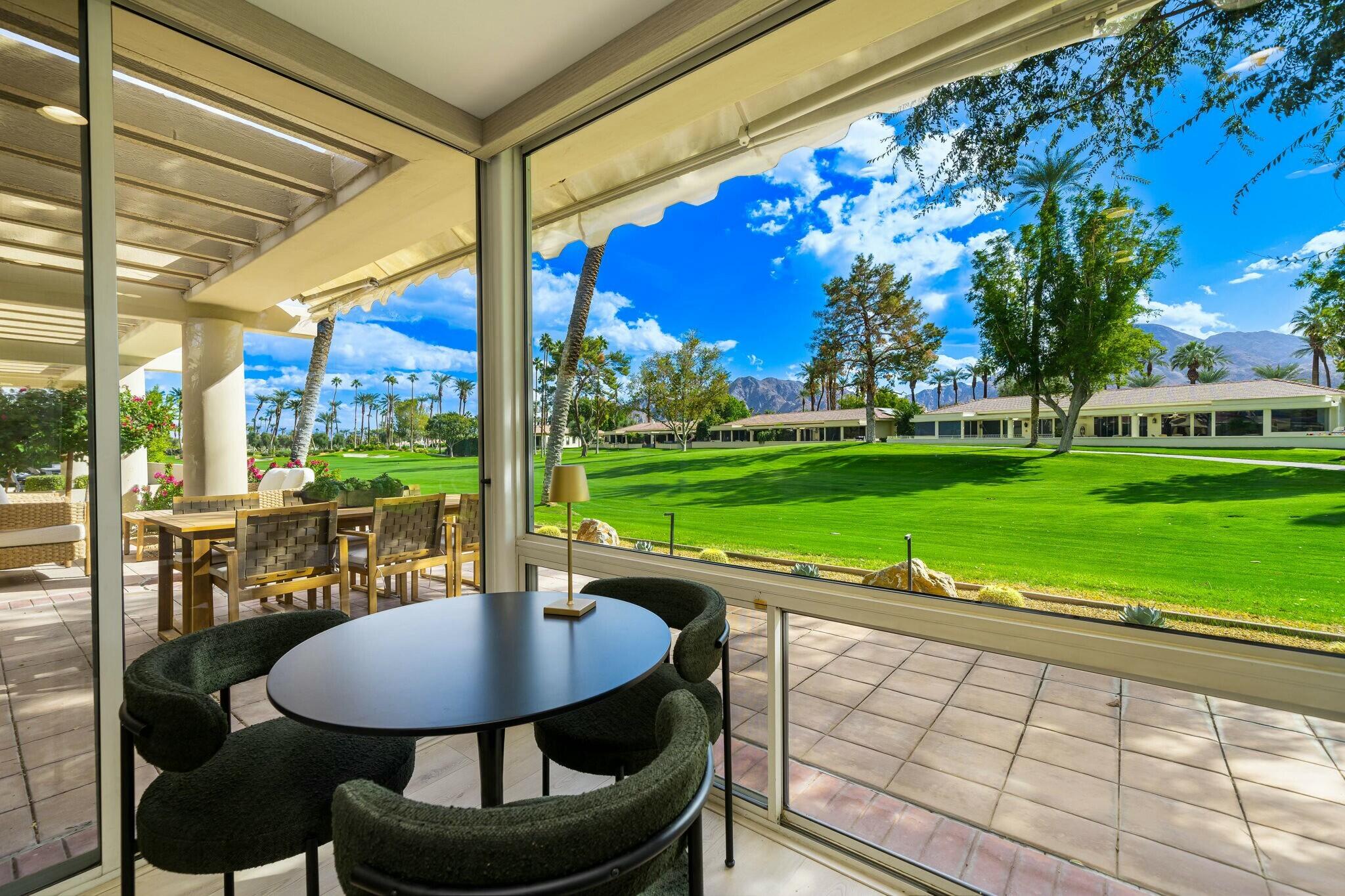 75405 Riviera Drive Indian Wells, CA 92210 - Photo 34 of 43 a view of a patio with a table chairs and a backyard