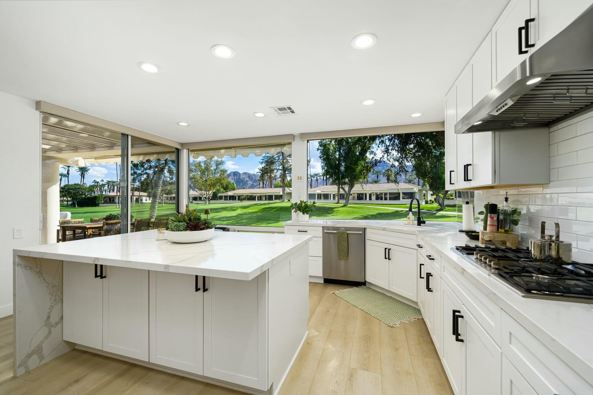 75405 Riviera Drive Indian Wells, CA 92210 - Photo 5 of 43 a kitchen with a sink stove and cabinets
