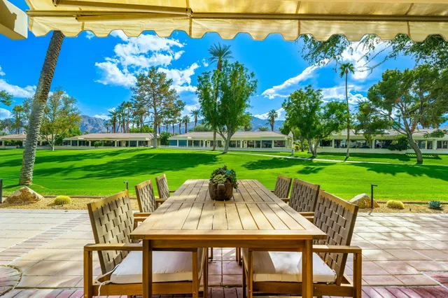 a view of a chairs and table in patio