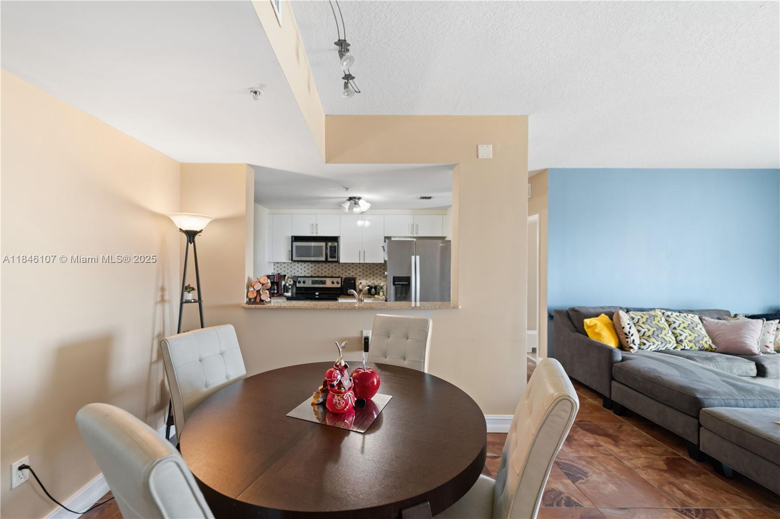 117 Northwest 42nd Avenue, Unit 1611 Miami, FL 33126 - Photo 11 of 20 a living room with furniture kitchen and a dining table