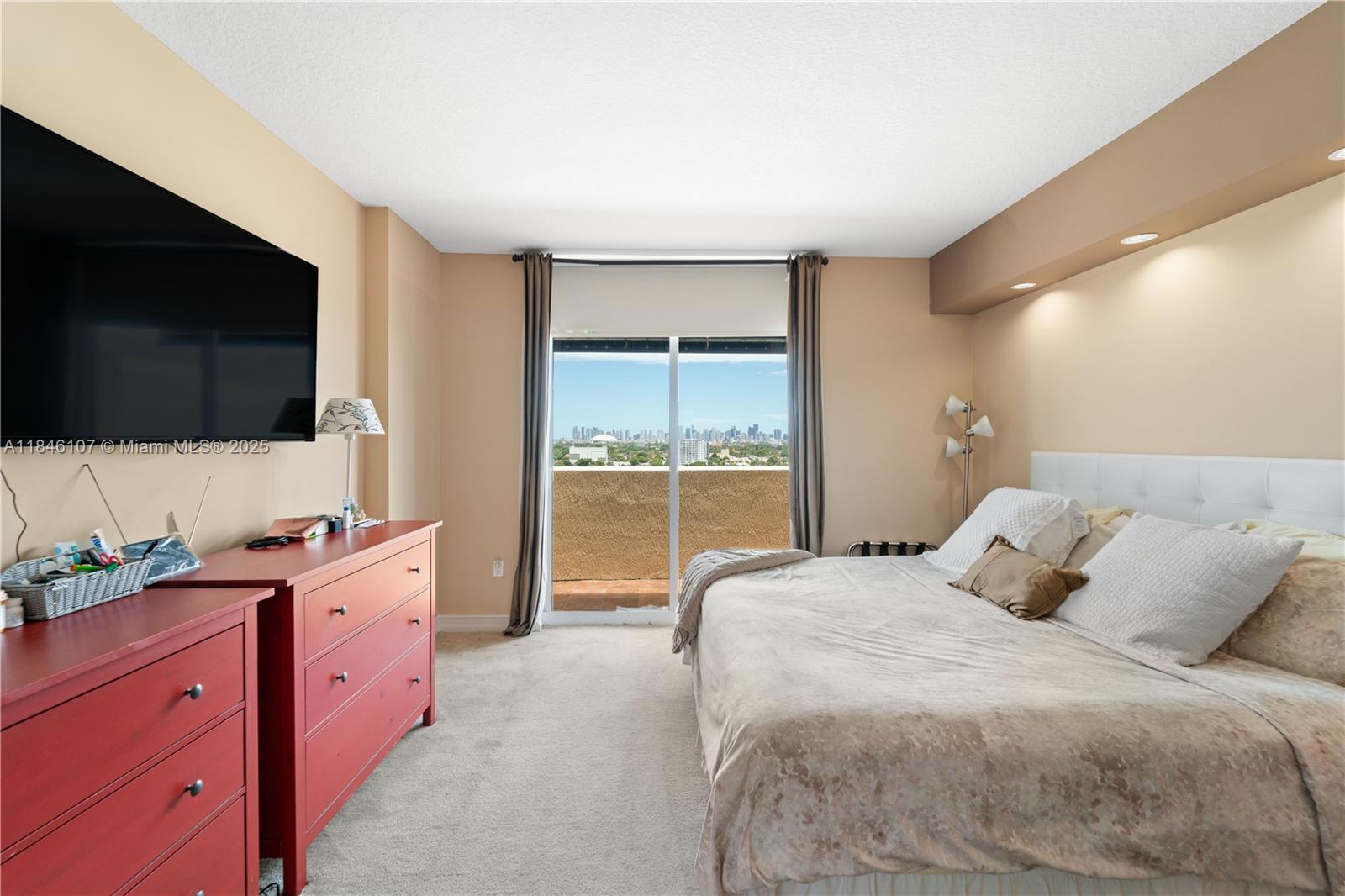 117 Northwest 42nd Avenue, Unit 1611 Miami, FL 33126 - Photo 18 of 20 a spacious bedroom with a bed and a flat screen tv