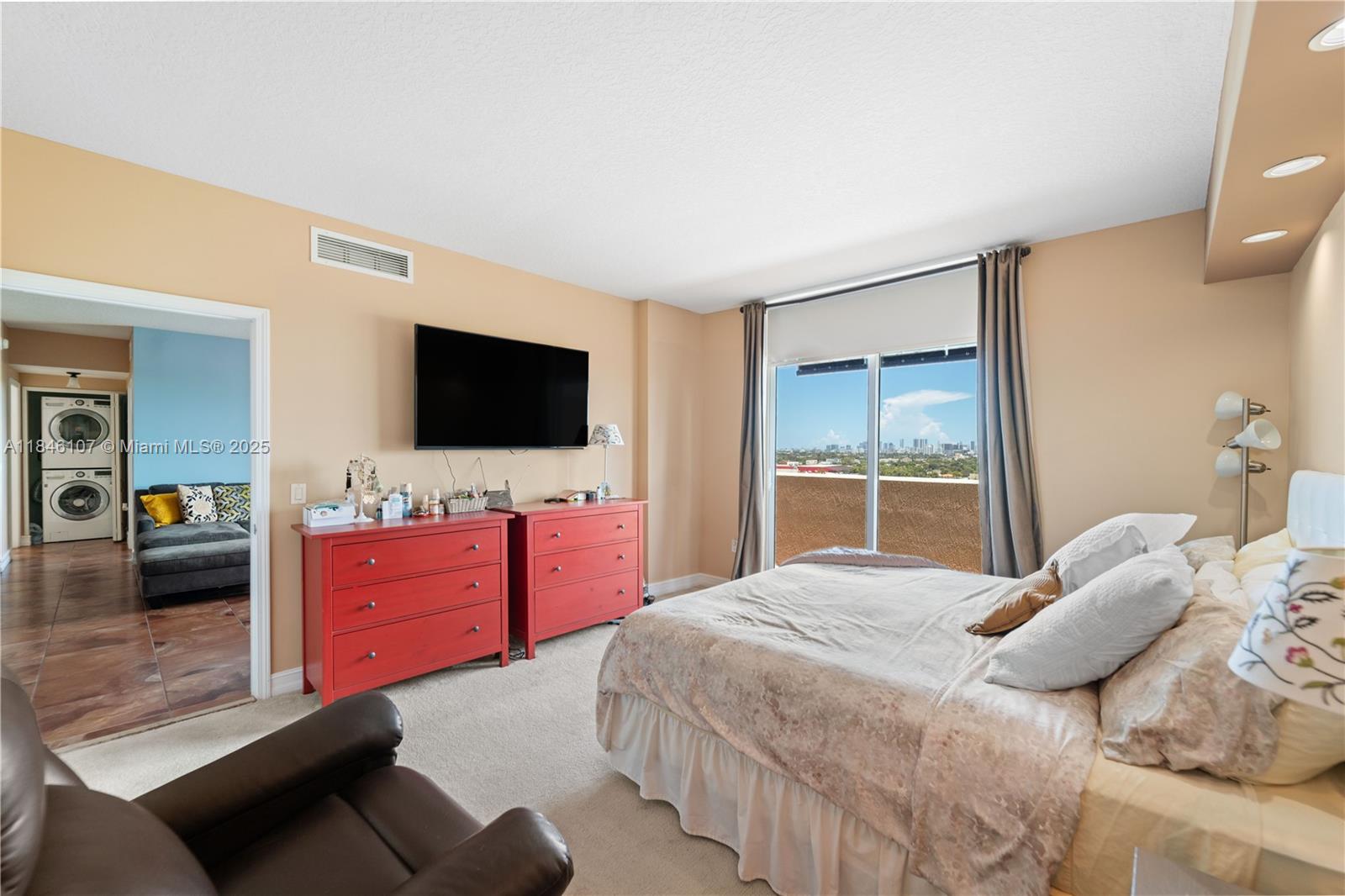 117 Northwest 42nd Avenue, Unit 1611 Miami, FL 33126 - Photo 20 of 20 a bedroom with a bed and a flat tv screen on dresser