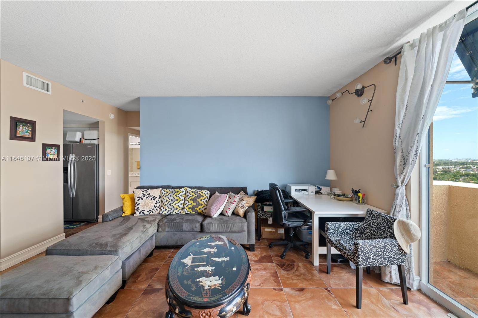 117 Northwest 42nd Avenue, Unit 1611 Miami, FL 33126 - Photo 3 of 20 a living room with furniture and a dining table