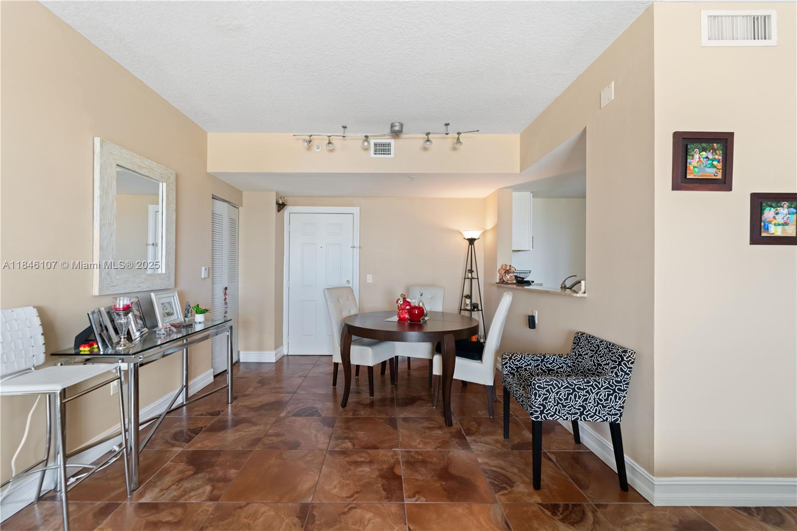 117 Northwest 42nd Avenue, Unit 1611 Miami, FL 33126 - Photo 4 of 20 a living room with furniture and a chair