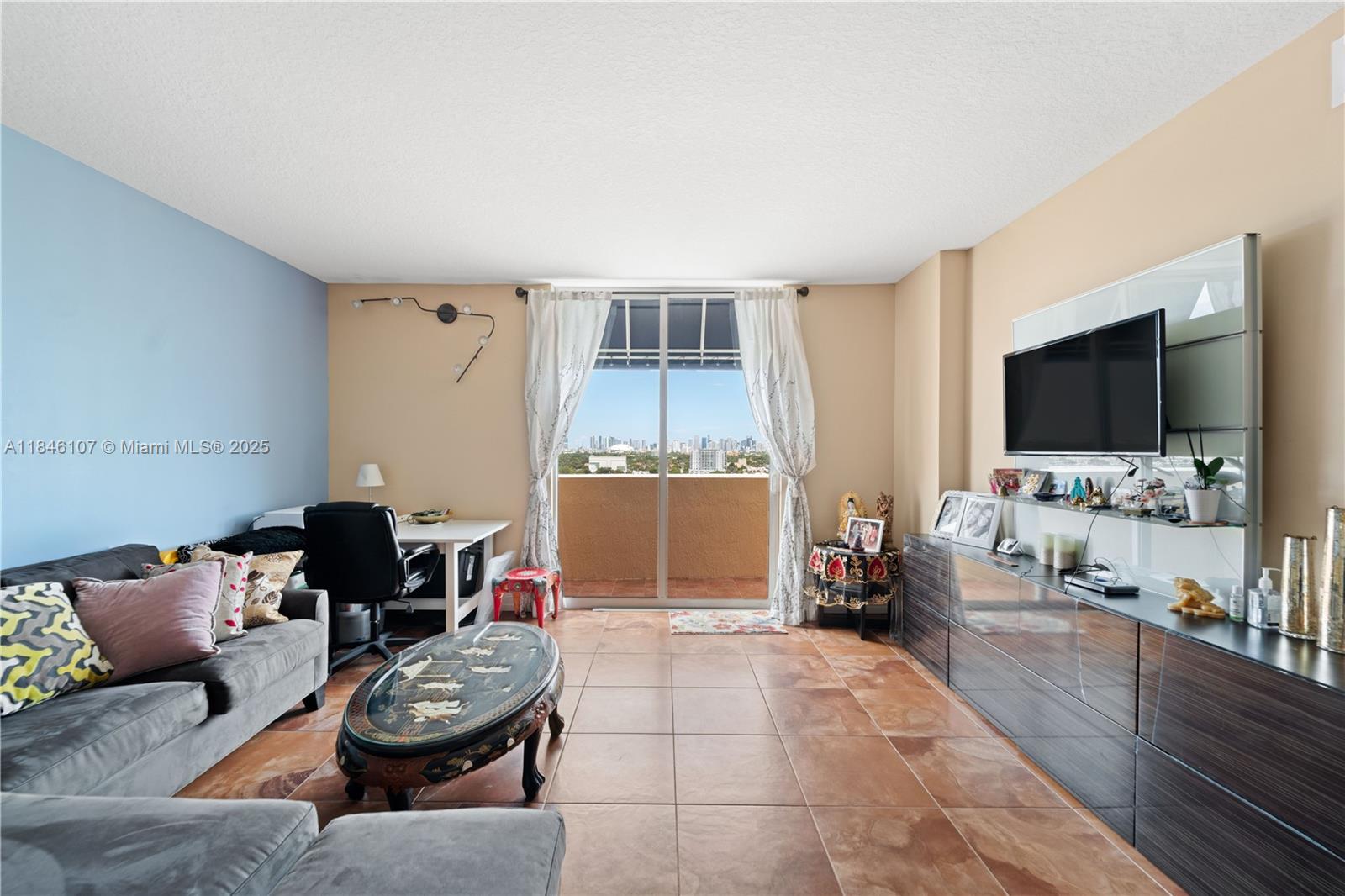 117 Northwest 42nd Avenue, Unit 1611 Miami, FL 33126 - Photo 9 of 20 a living room with furniture and a flat screen tv