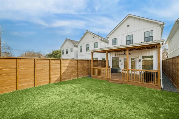 a view of a house with a yard and sitting area