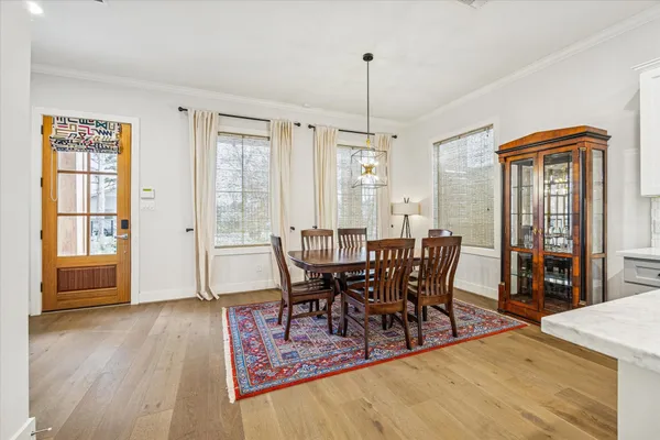 a view of a dining room with furniture window and wooden floor
