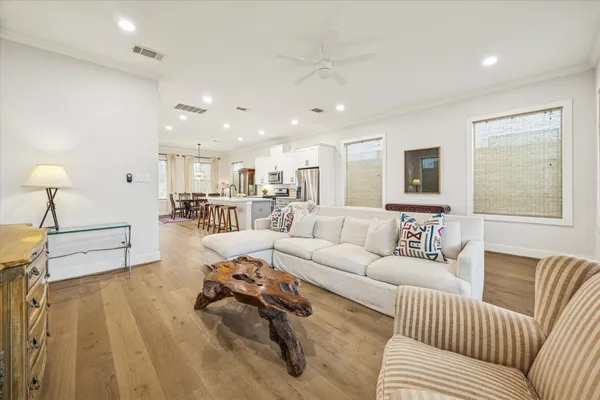 a dining room with furniture and wooden floor