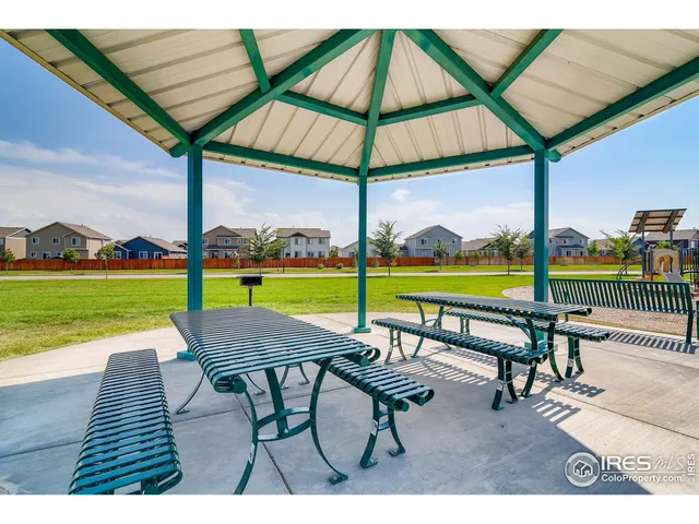 a view of a table and chairs under an umbrella
