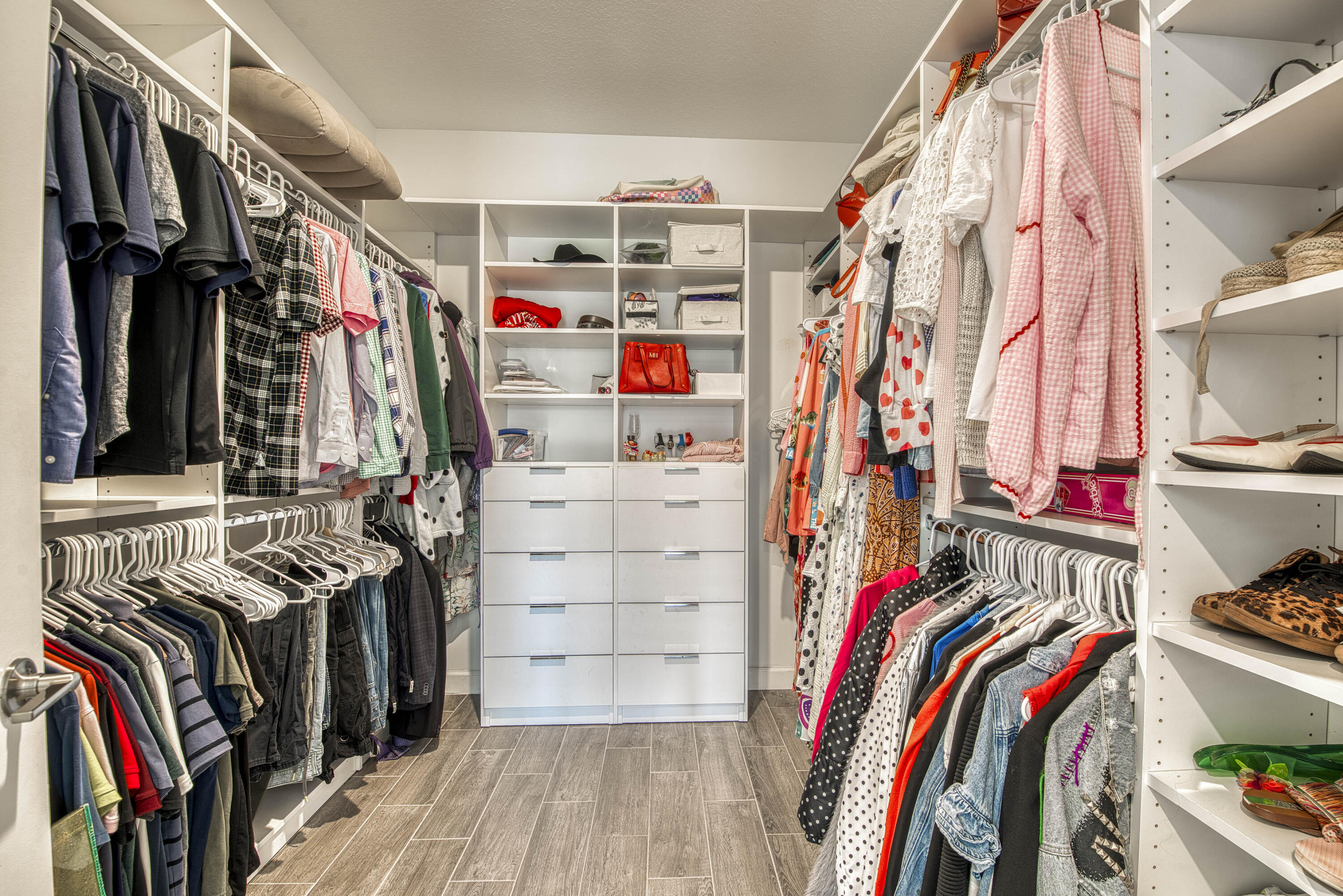 1463 Heron Nook Road Loxahatchee, FL 33470 - Photo 16 of 87 a view of walk in closet with clothes and shoes