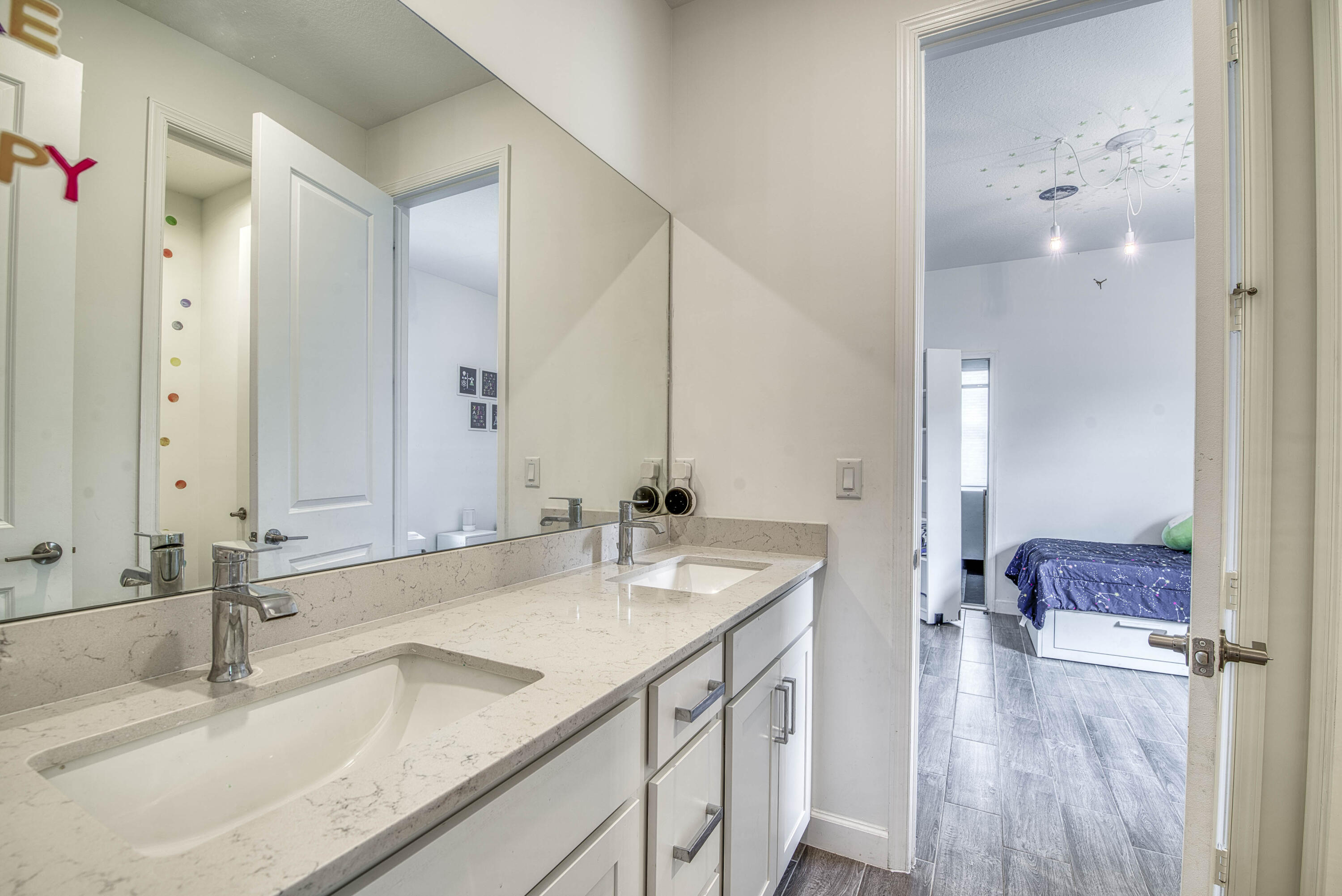 1463 Heron Nook Road Loxahatchee, FL 33470 - Photo 22 of 87 a bathroom with a sink and a mirror