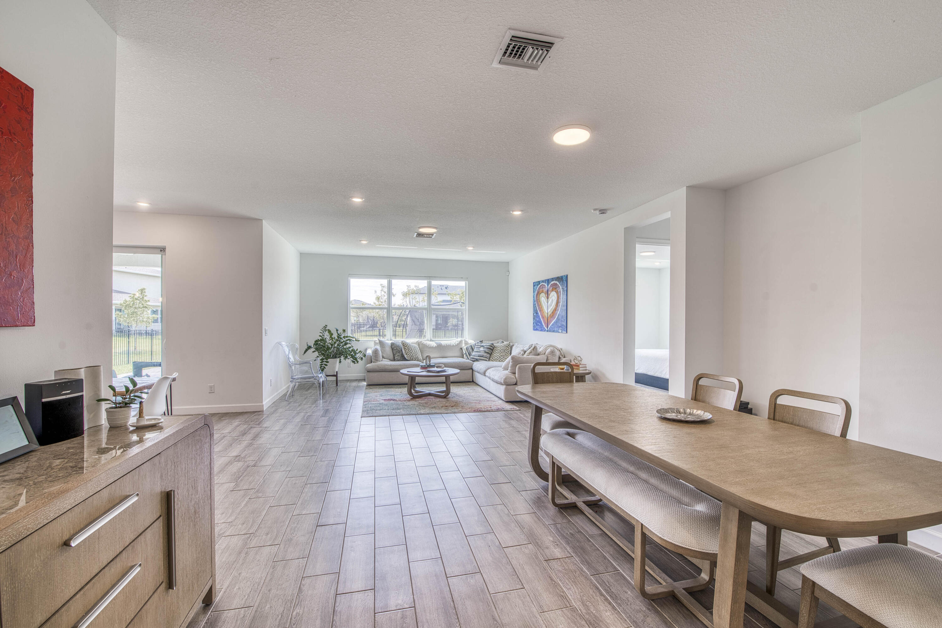 1463 Heron Nook Road Loxahatchee, FL 33470 - Photo 3 of 87 a living room with furniture a wooden floor and a sink