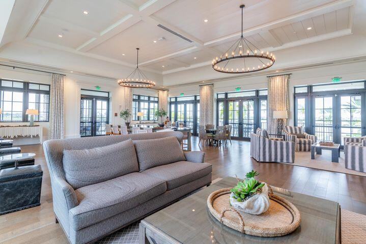 1463 Heron Nook Road Loxahatchee, FL 33470 - Photo 50 of 87 a living room with furniture kitchen and a chandelier