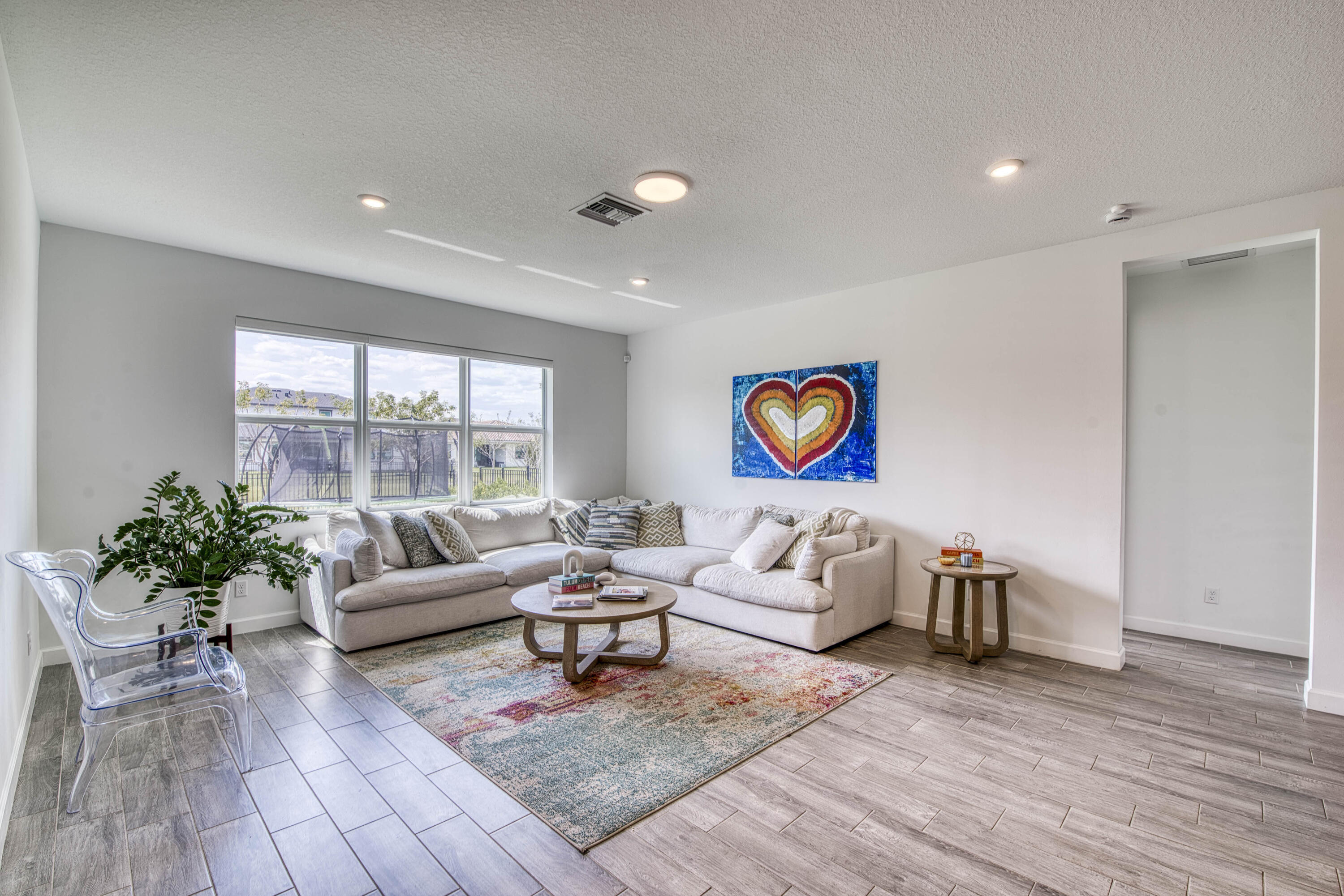 1463 Heron Nook Road Loxahatchee, FL 33470 - Photo 5 of 87 a living room with furniture and wooden floor