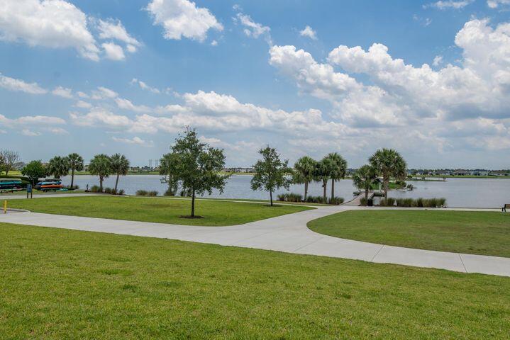 1463 Heron Nook Road Loxahatchee, FL 33470 - Photo 64 of 87 a view of a golf course with a lake