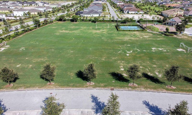 1463 Heron Nook Road Loxahatchee, FL 33470 - Photo 84 of 87 an aerial view of residential houses with outdoor space and trees